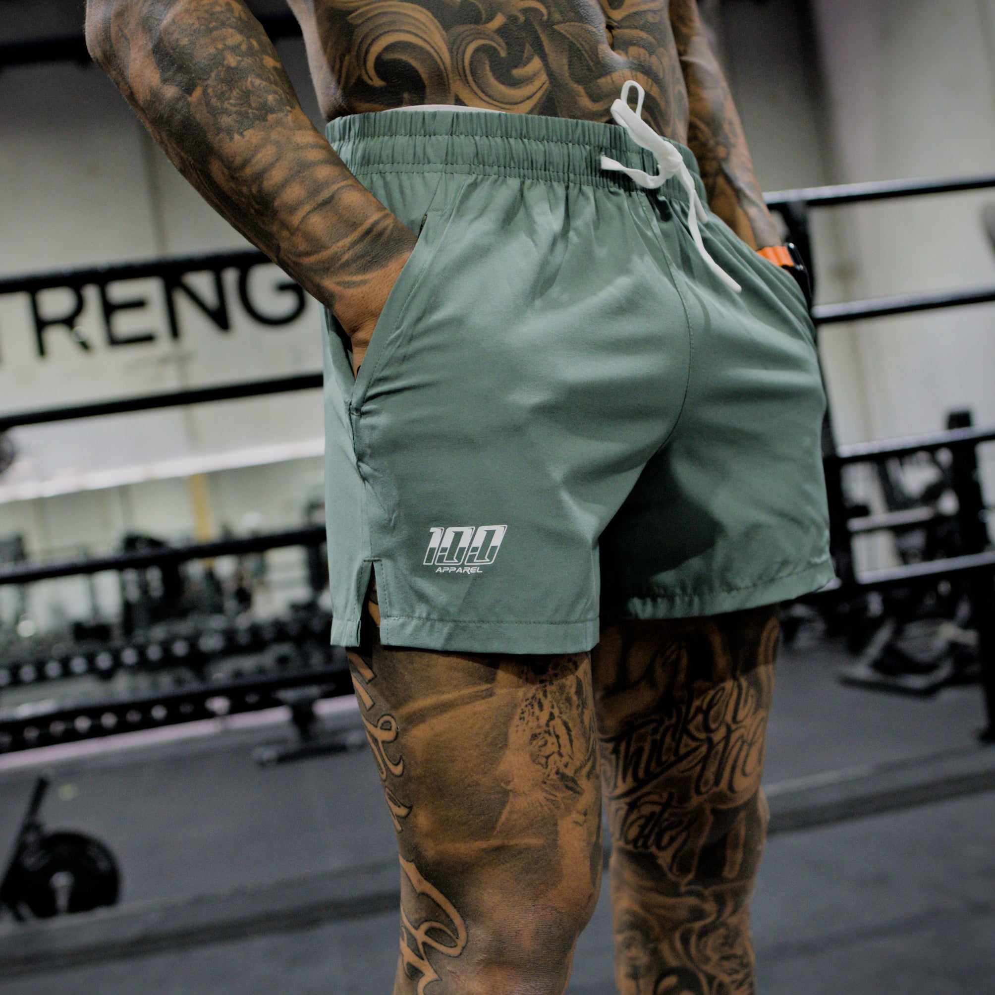 man wearing sage green shorts with white lace 